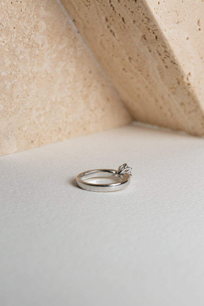 flower setting on a white gold diamond engagement ring