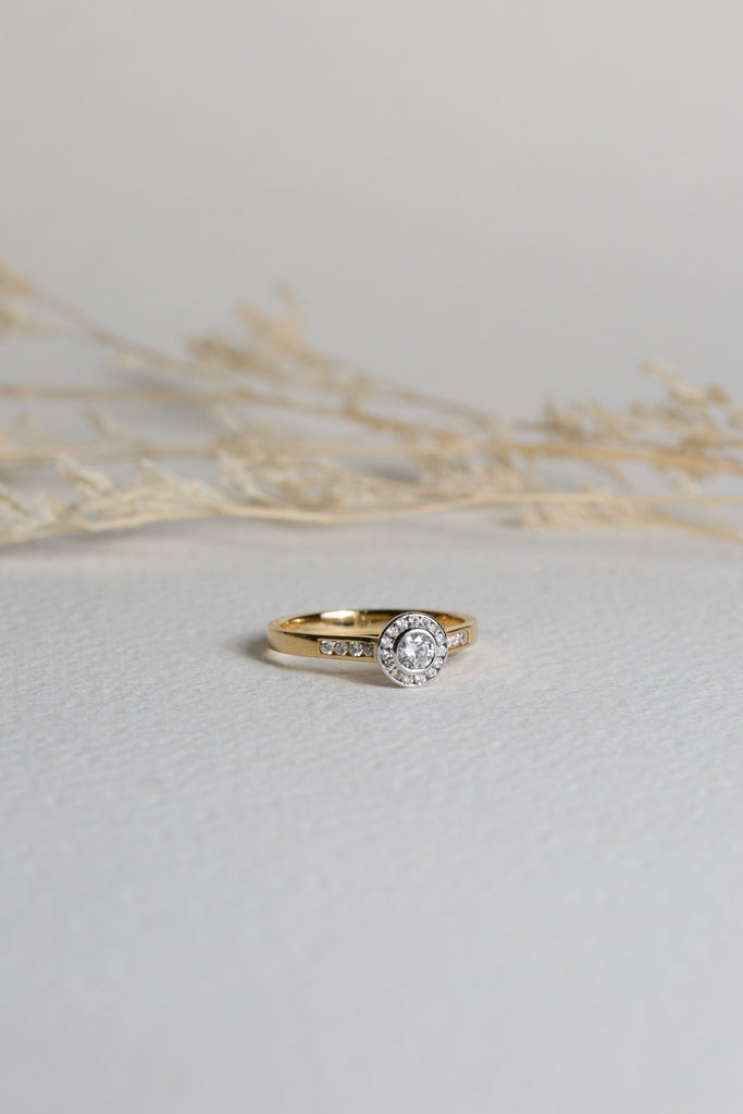 Diamond halo engagement ring, set in gold