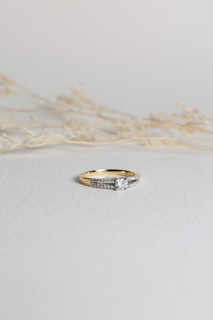 Gold and diamond engagement ring with a split shank