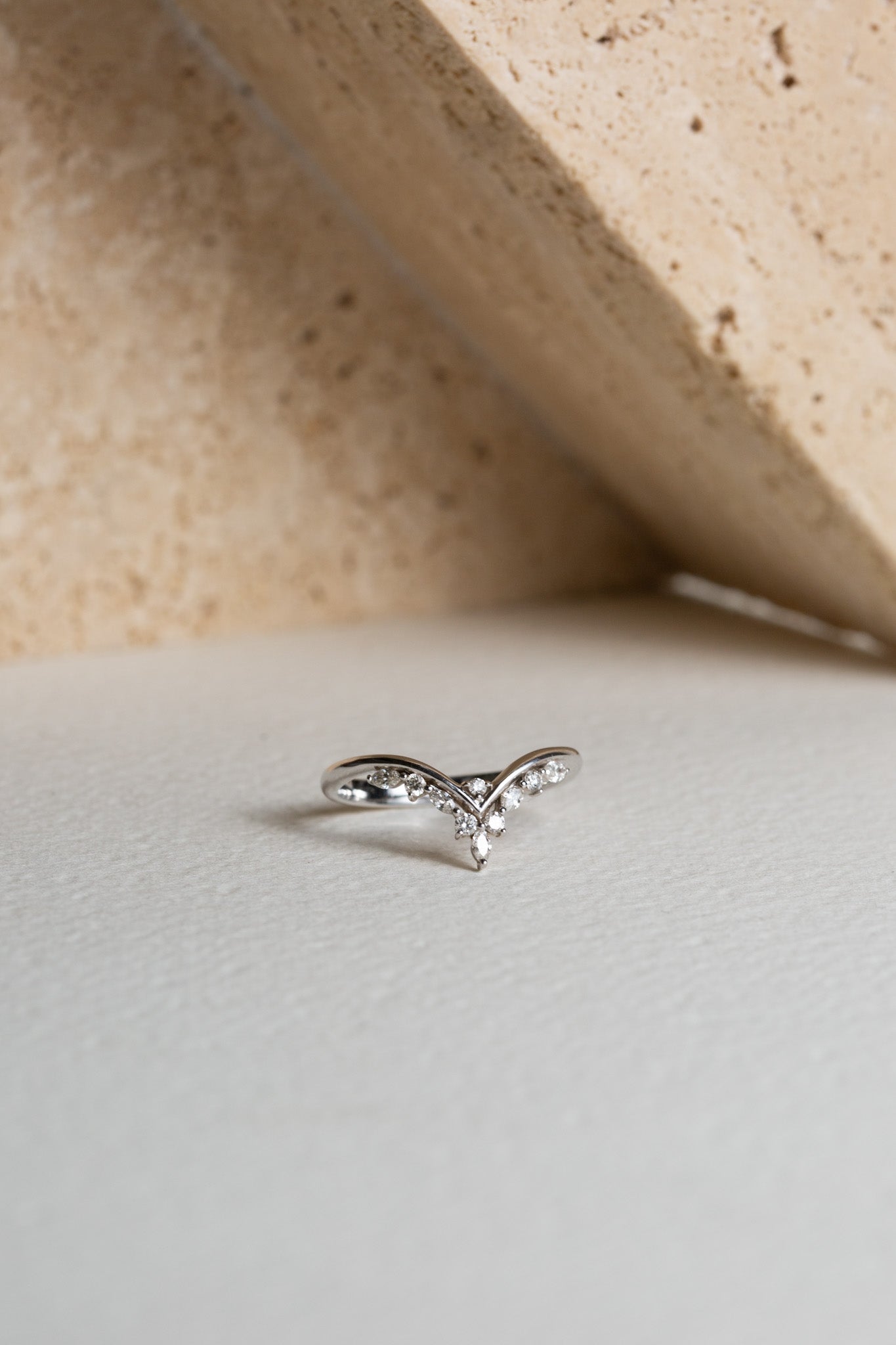 White gold diamond wedding ring which is shaped to fit around an engagement ring