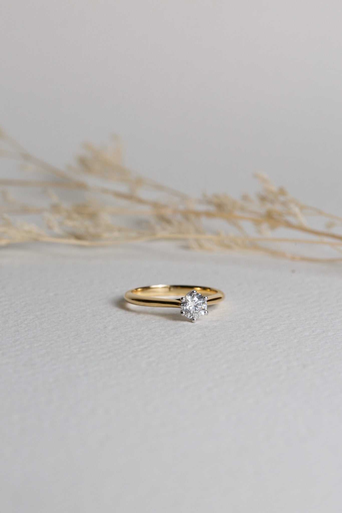 Diamond solitaire engagement ring with an 18ct gold band