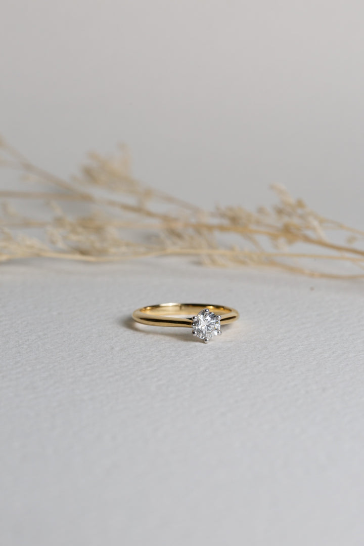 Diamond solitaire engagement ring with an 18ct gold band