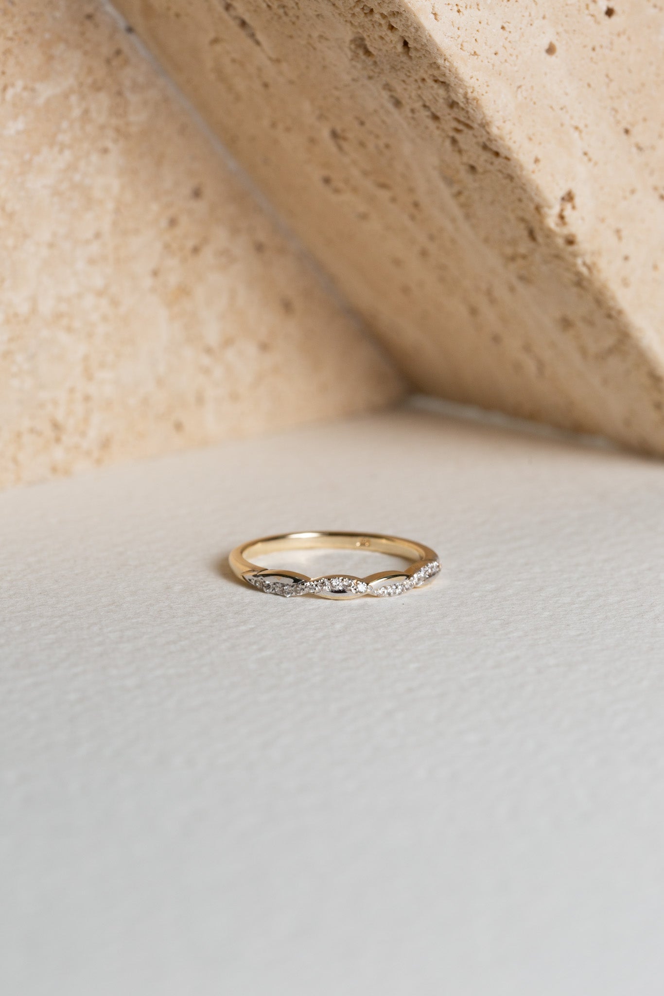 Gold and diamond twisted wedding band