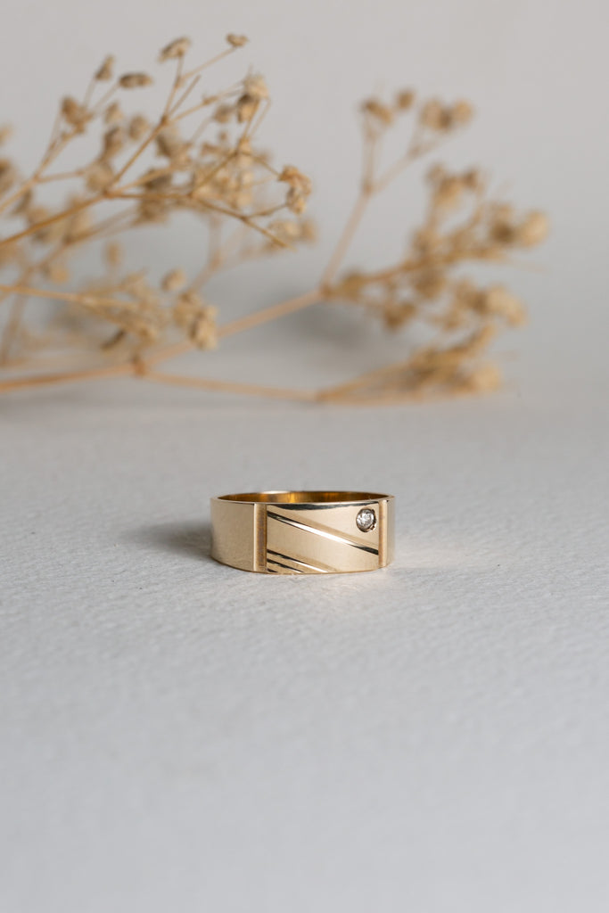 Mens gold signet ring with a diamond set in the corner