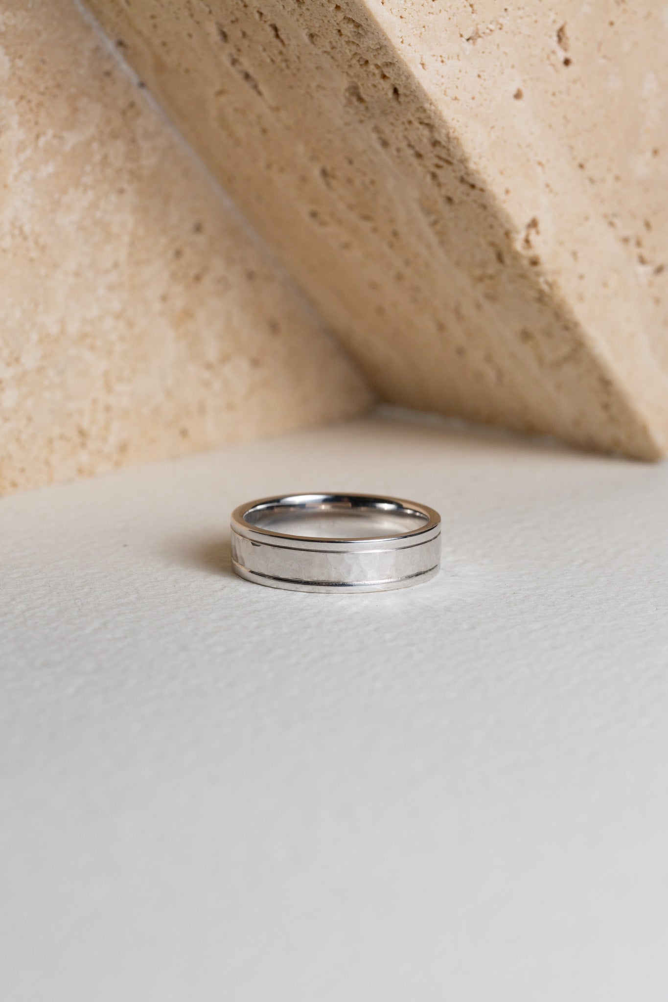Mens white gold wedding ring with a hammered finish through the centre