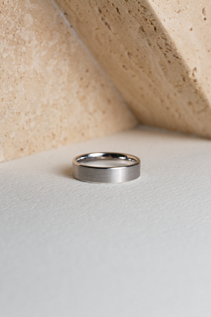 Mens white gold wedding ring with a brushed texture