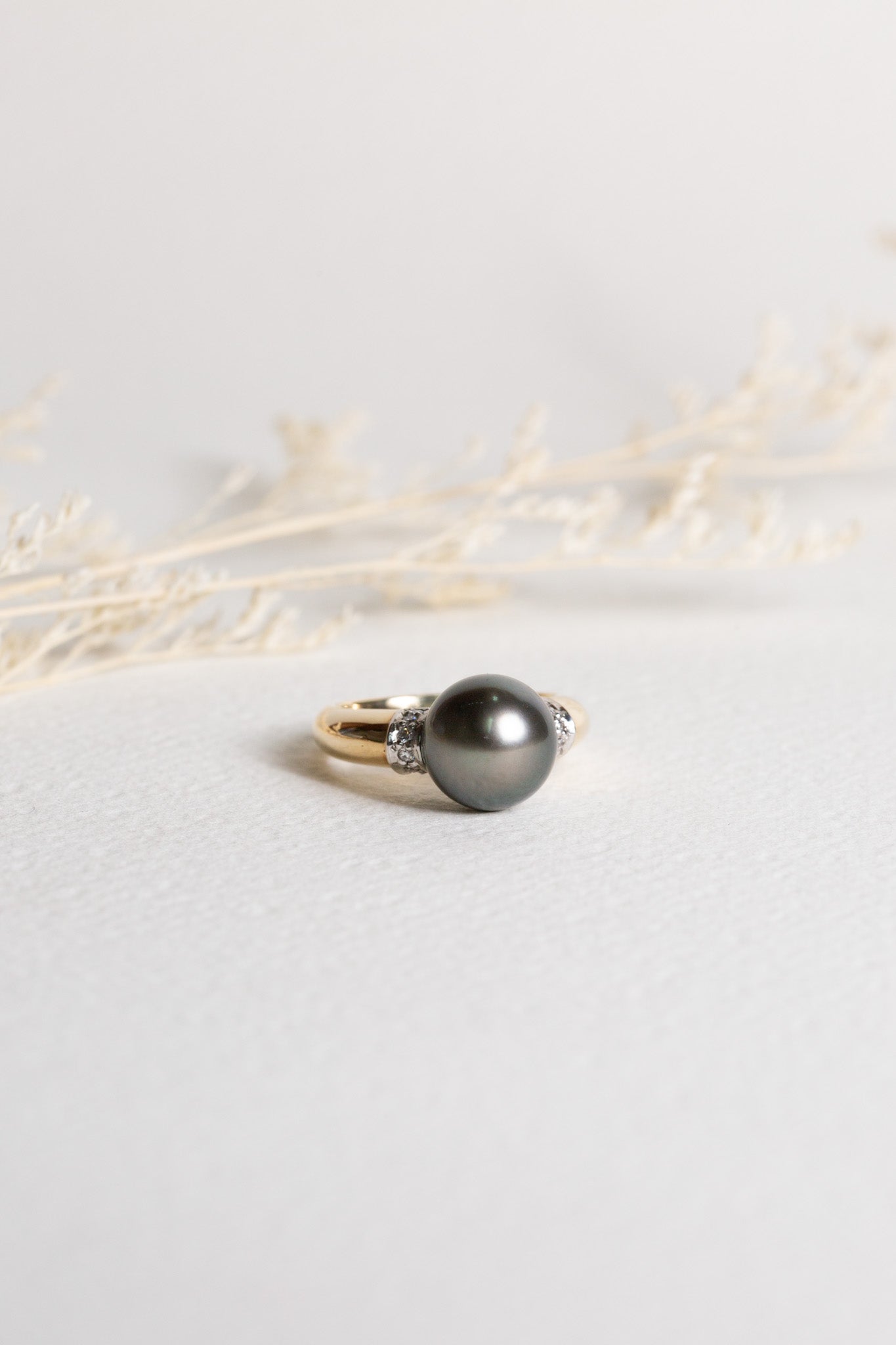 Pearl and diamond ring, set in gold. The pearl is a large black pearl.