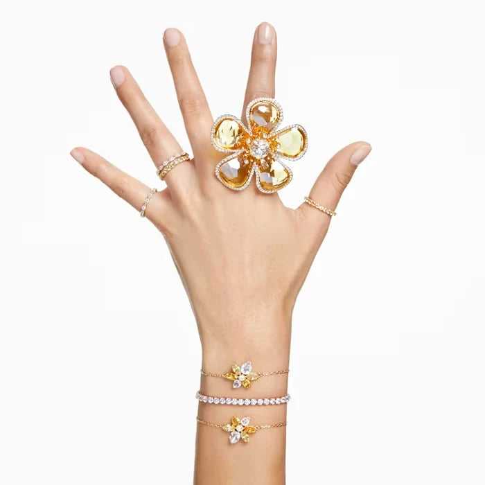Swarovski gold bracelets shown on a models hand