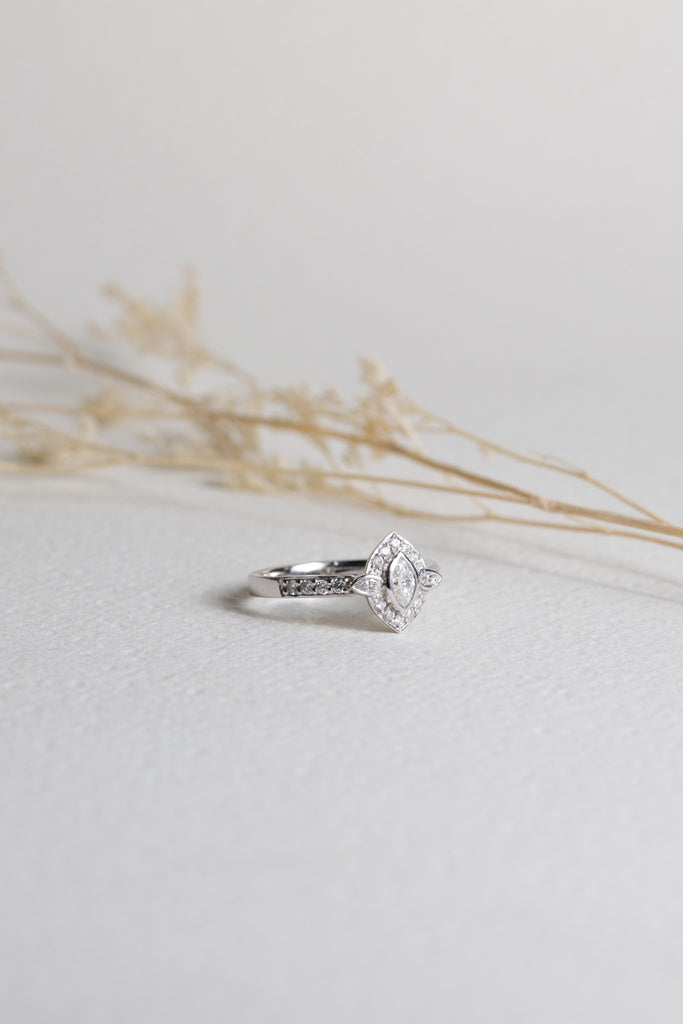 White gold dress ring set with a marquise-cut diamond in the centre