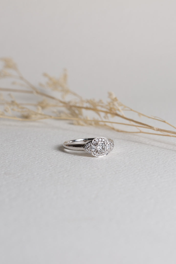 White gold dress ring with a cushion cut diamond in the centre