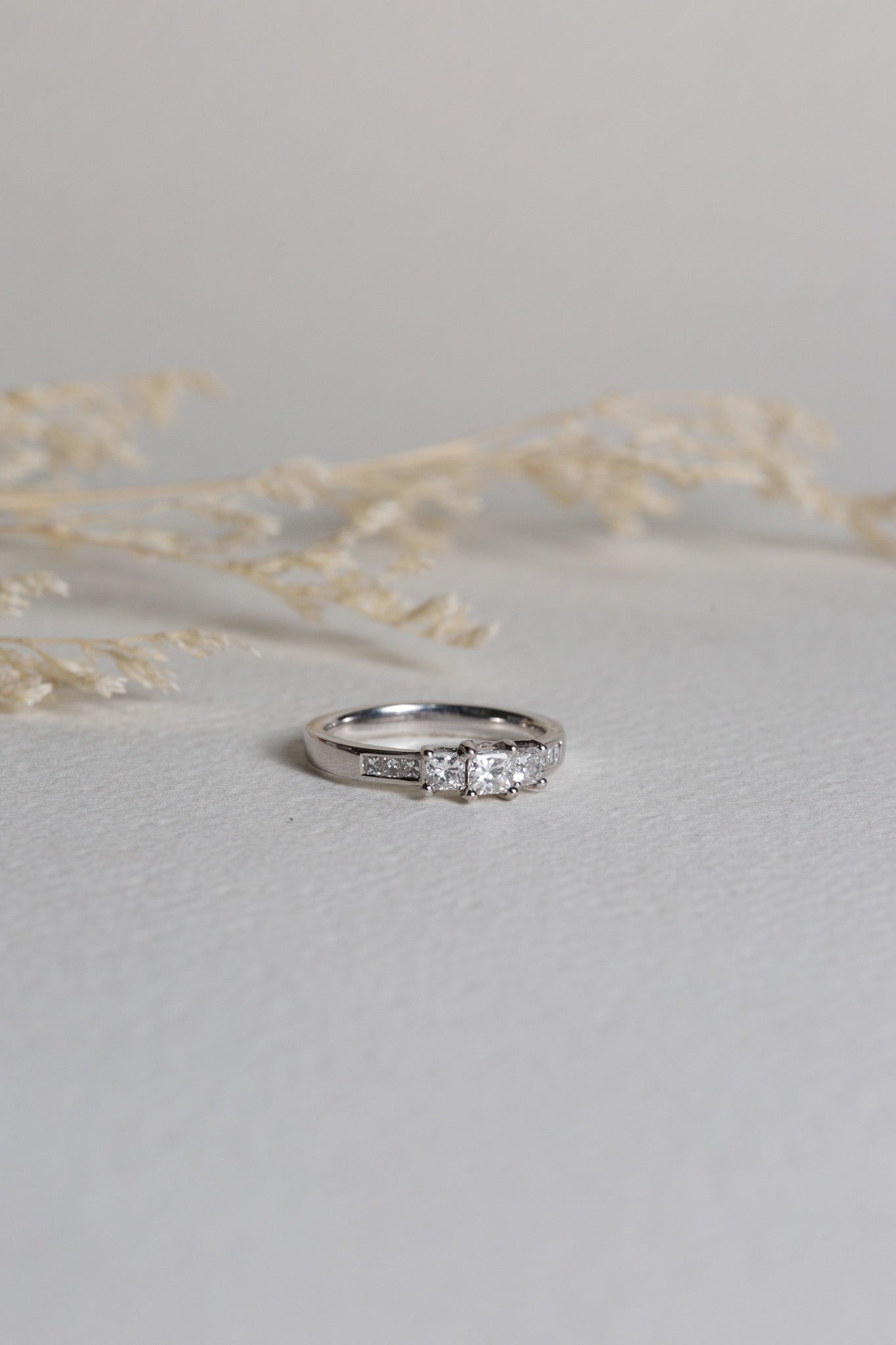 White gold diamond engagement ring.  It is set with 3 diamonds and smaller ones on the shoulders.