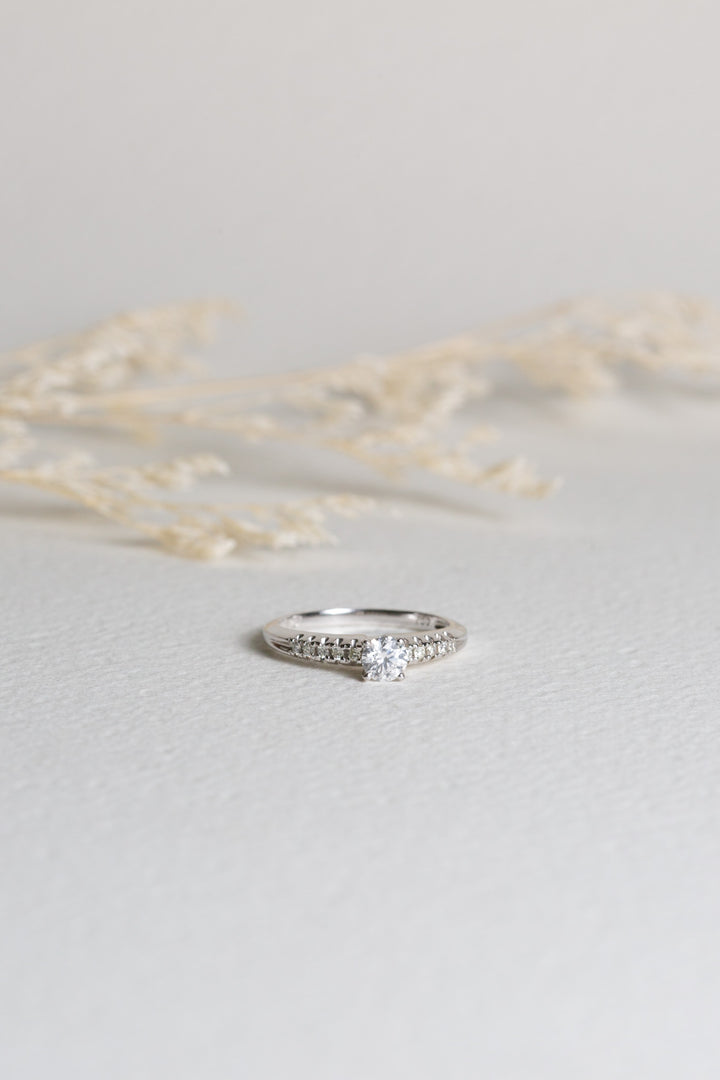 White gold diamond engagement ring with diamonds set on the shoulders