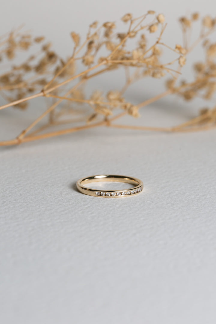 Gold and diamond channel-set wedding ring