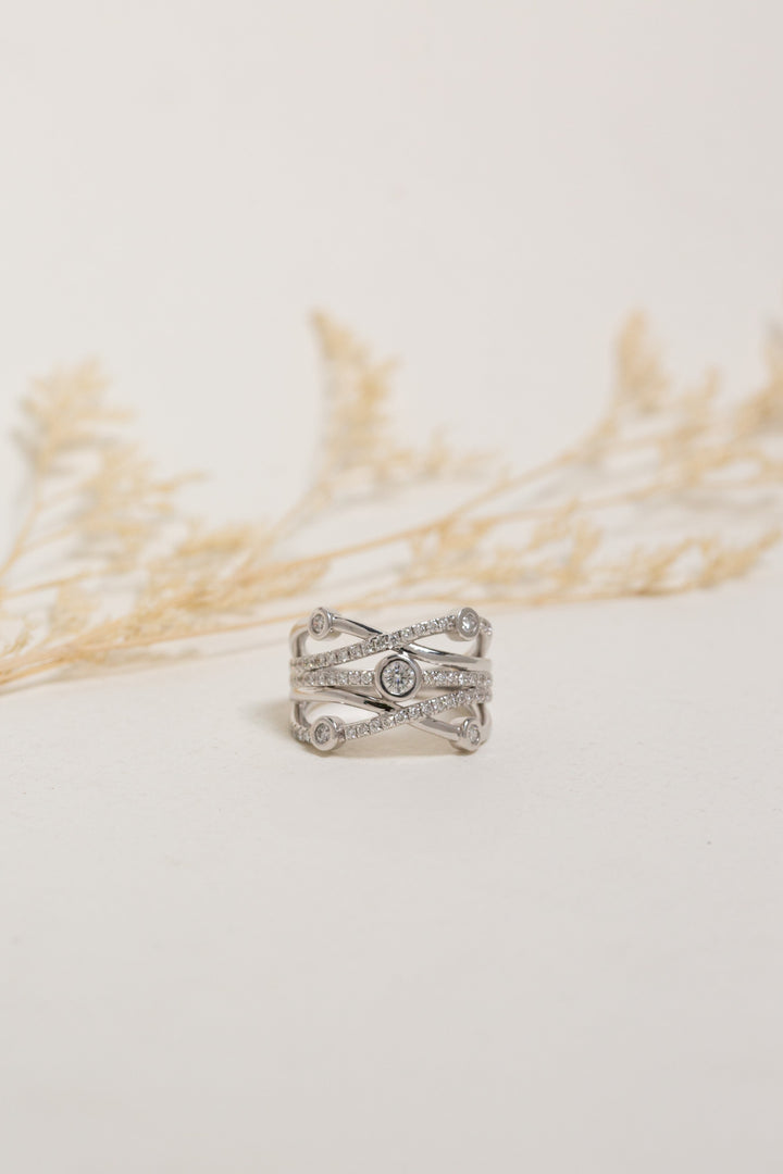 Wide white gold diamond dress ring.  The ring has large bezel-set diamonds and smaller claw-set diamonds.