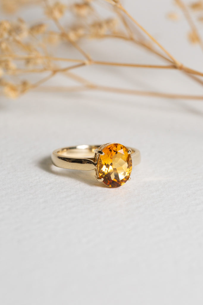 Minimalist gold ring set with a single citrine gemstone