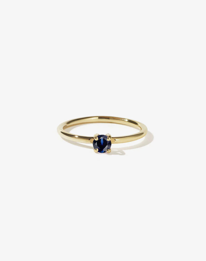 Dainty gold ring set with a single sapphire