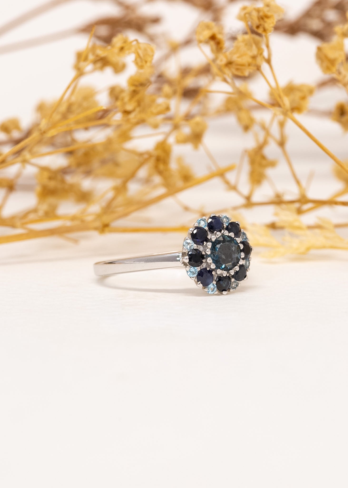 Étoile Blue Topaz & Sapphire Ring in 9ct white gold, styled with dried flowers