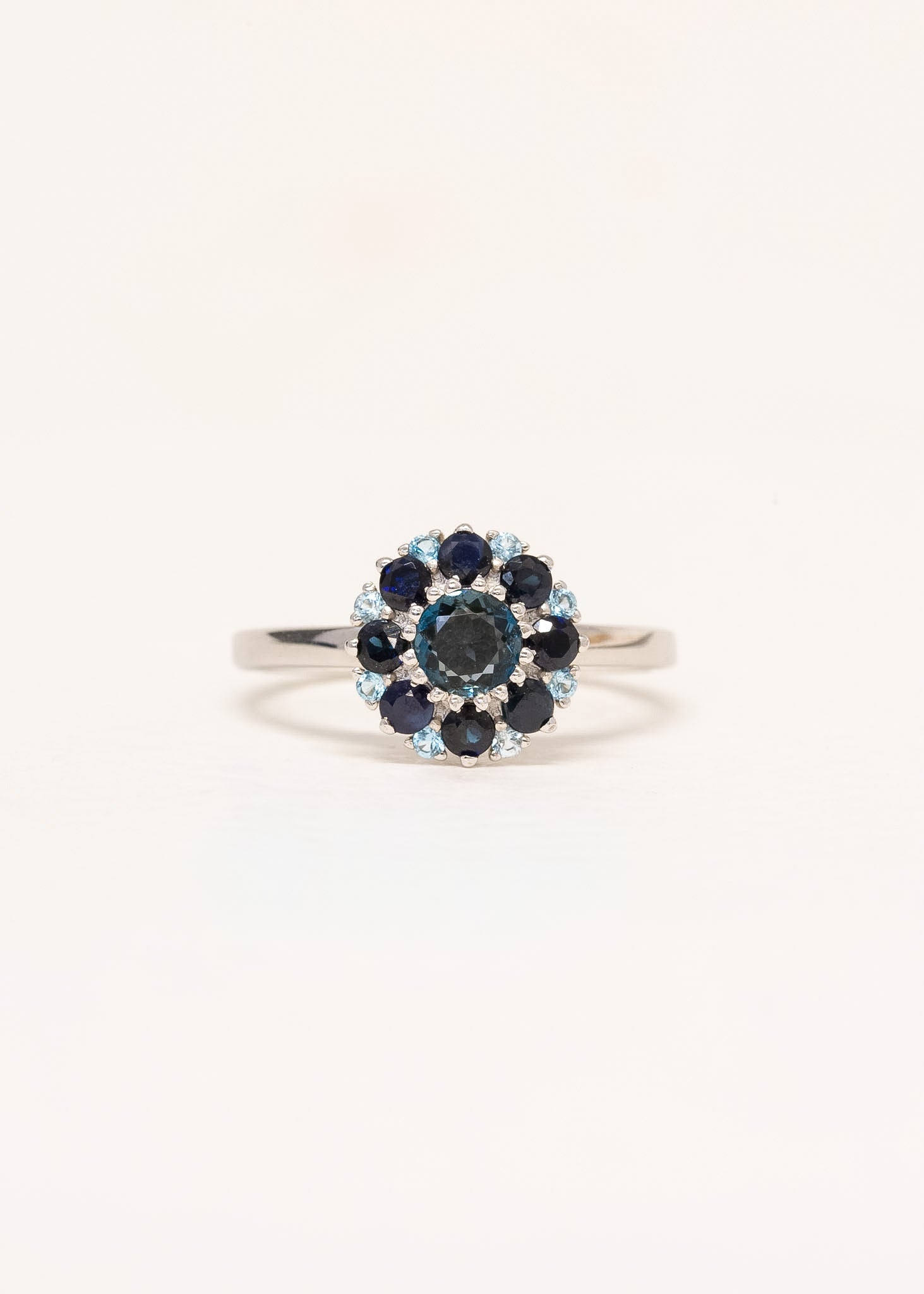 Close-up of Étoile ring showing sapphire and blue topaz cluster halo in 9ct white gold