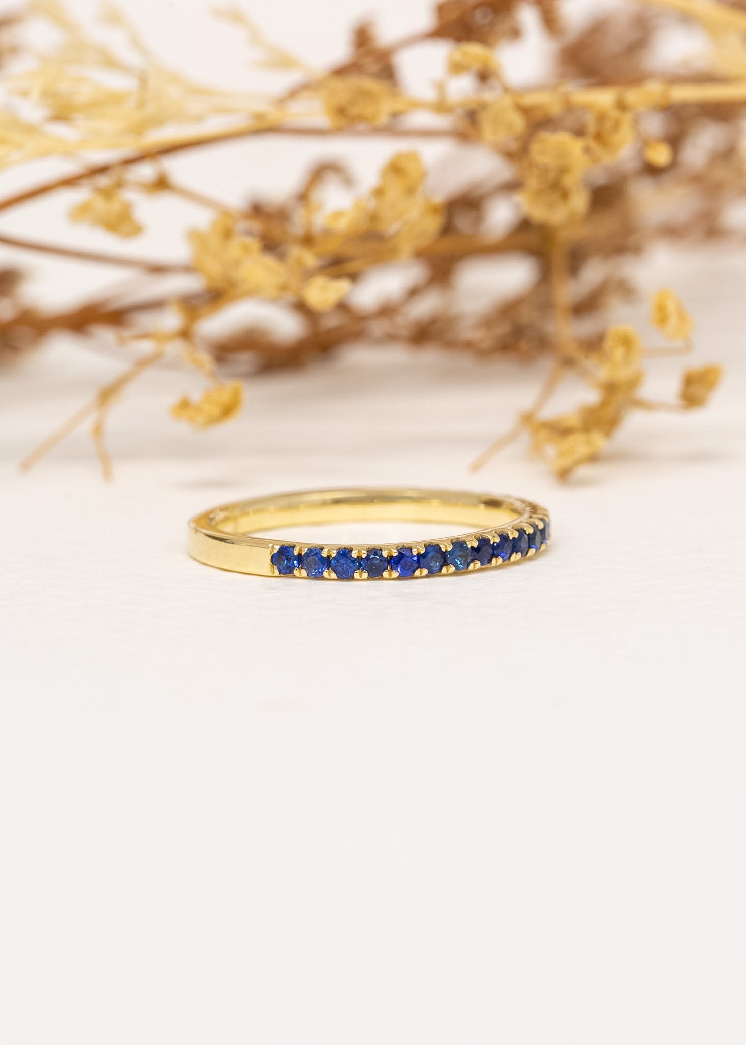 Sienne Sapphire Band in 9ct yellow gold, styled with dried flowers