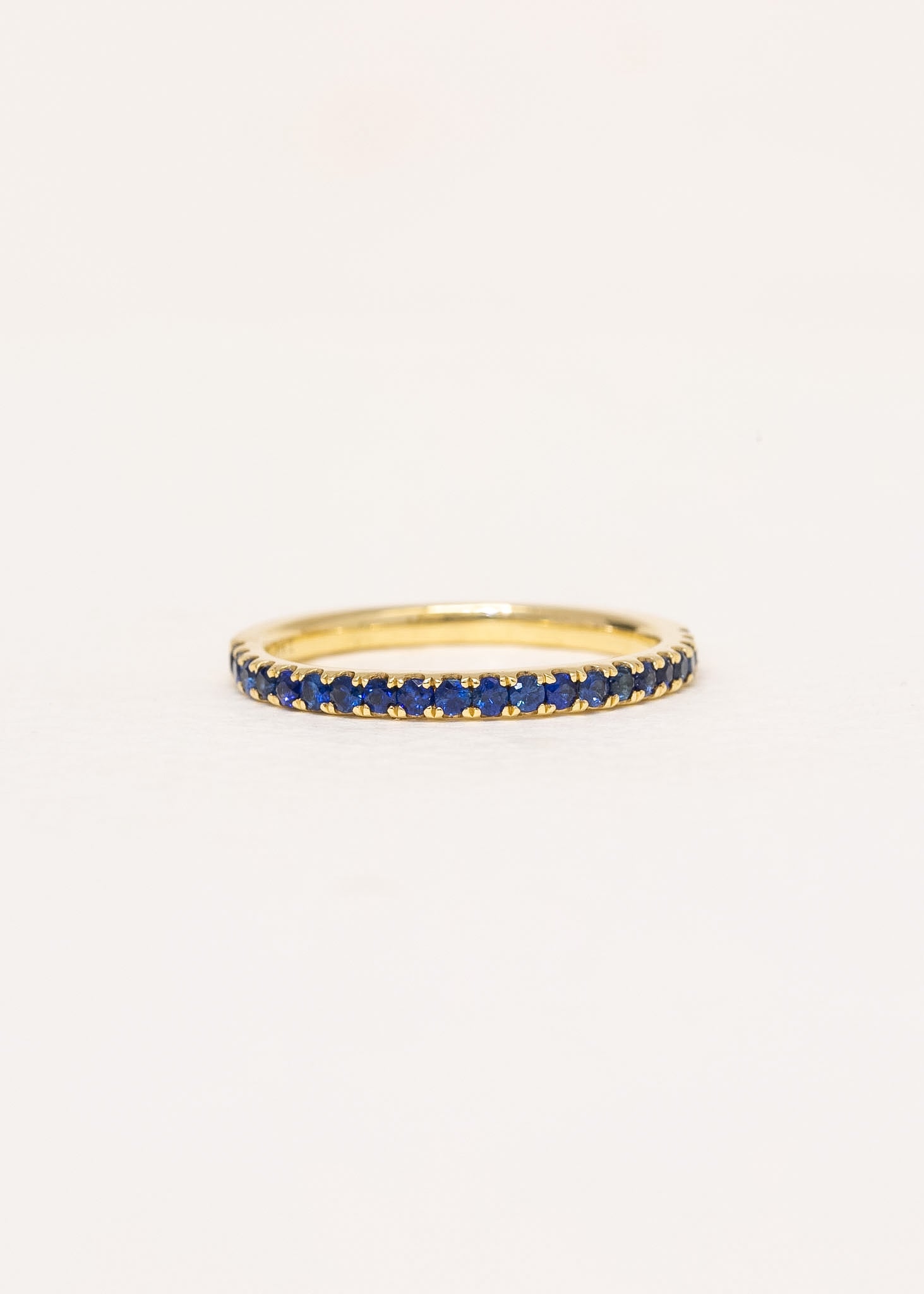 Close-up of Sienne Sapphire Band showing row of blue sapphires in 9ct yellow gold