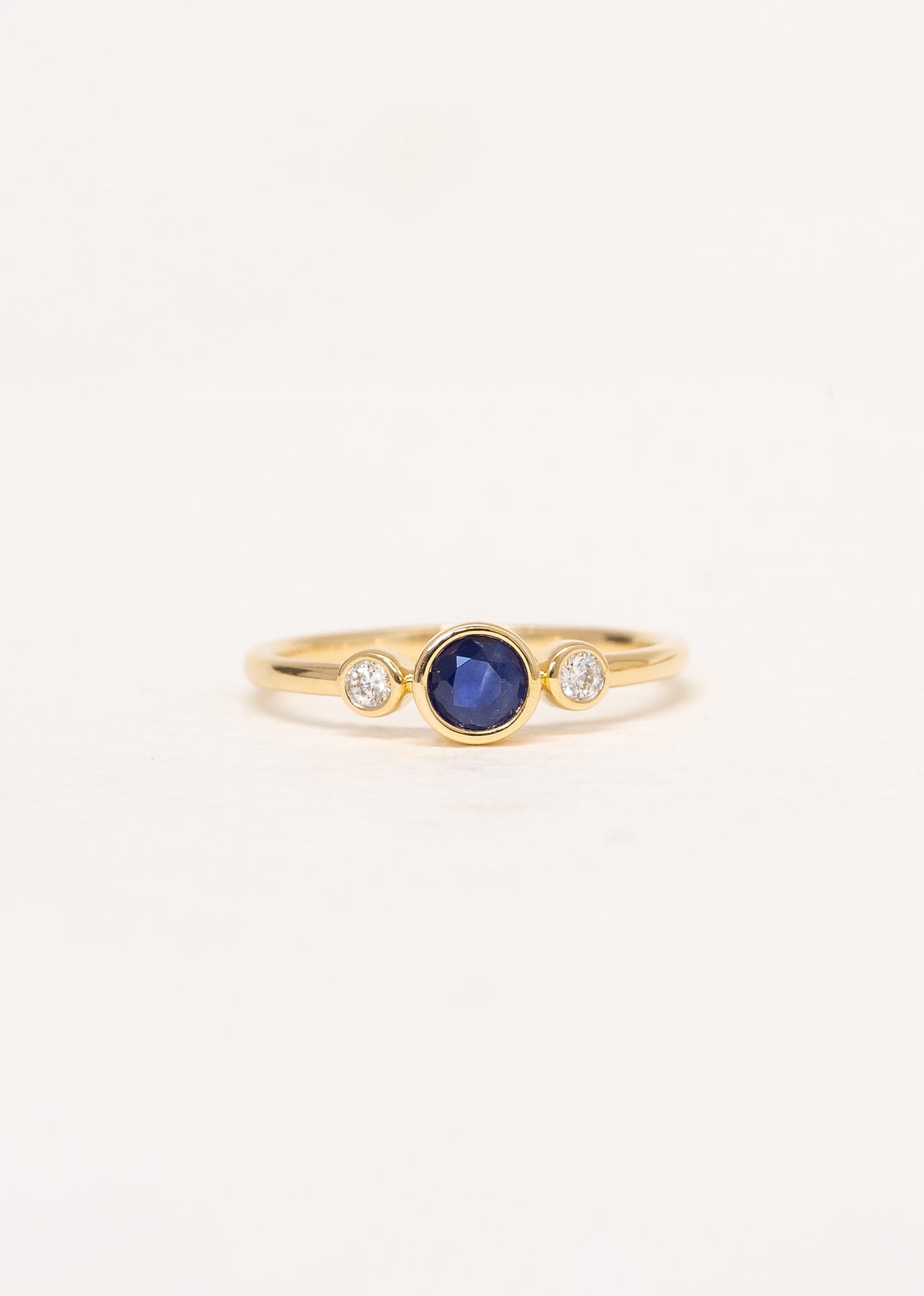 Close-up of Aria Sapphire Ring showing natural blue sapphire and diamond detail in 9ct yellow gold