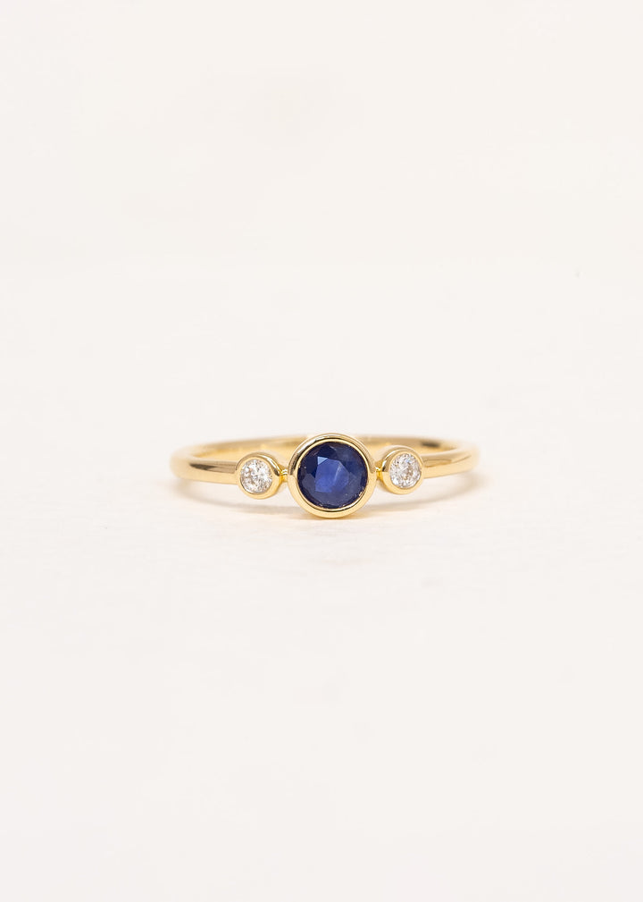Close-up of Aria Sapphire Ring showing natural blue sapphire and diamond detail in 9ct yellow gold