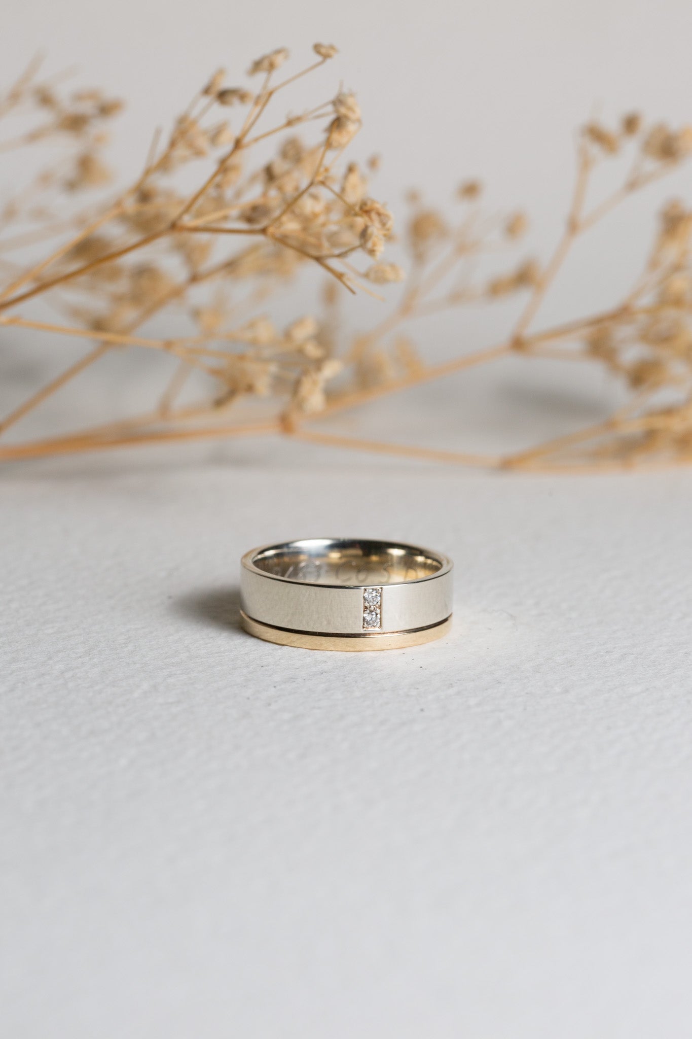 Mens white gold wedding ring with diamonds set in it
