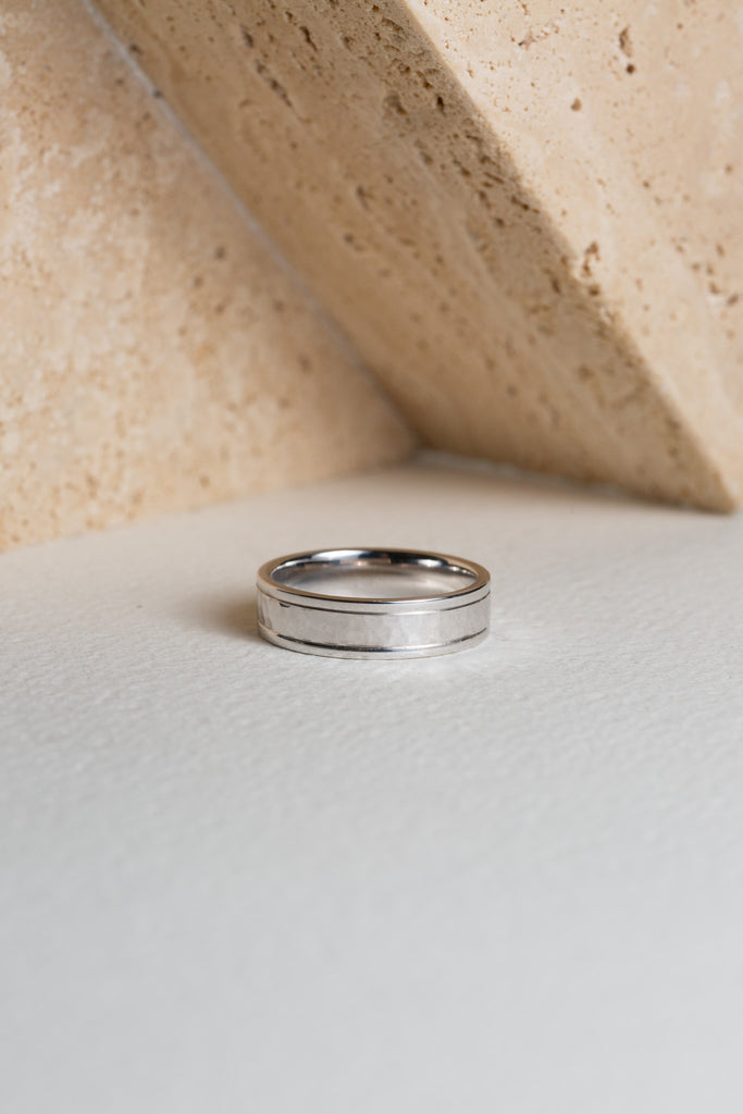 Mens white gold wedding ring with a hammered finish through the centre