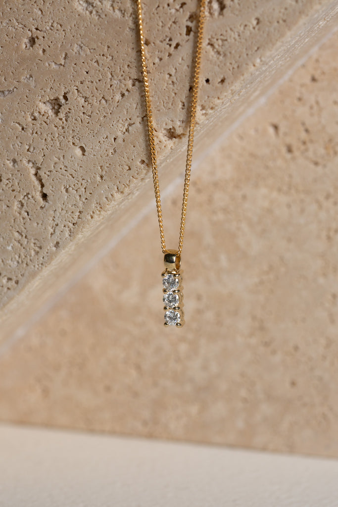 Trilogy diamond pendant on a gold chain