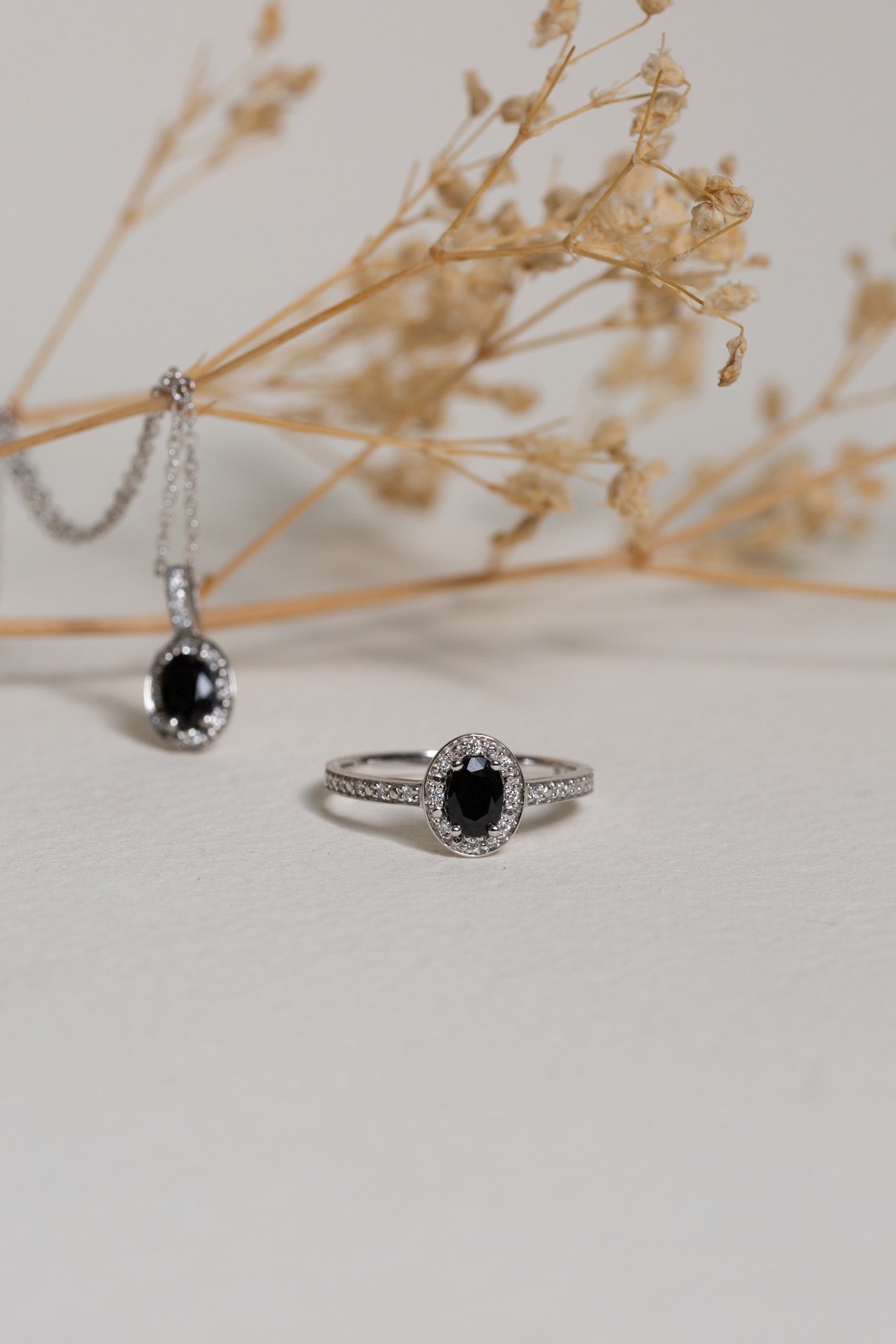 Matching white gold sapphire and diamond ring and pendant set