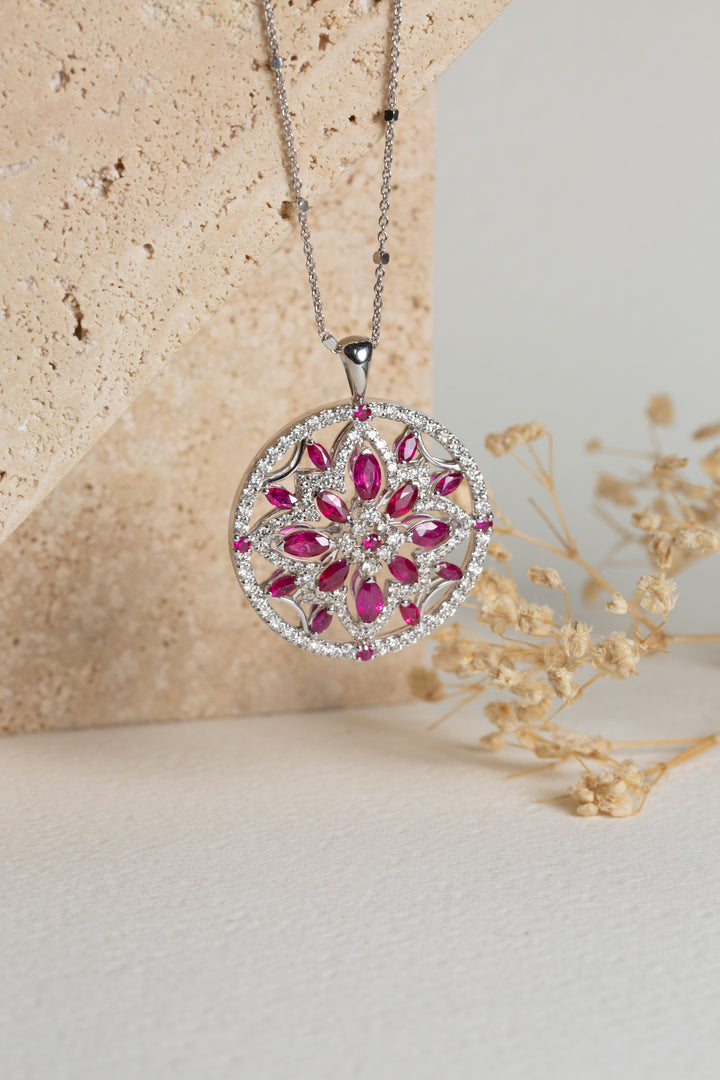 white gold pendant with rubies and diamonds set in a circle