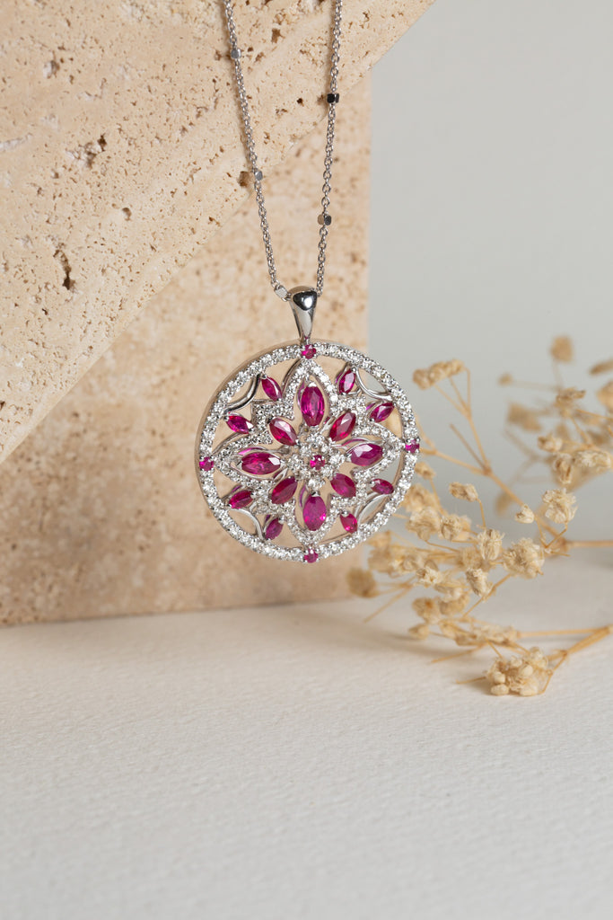 white gold pendant with rubies and diamonds set in a circle