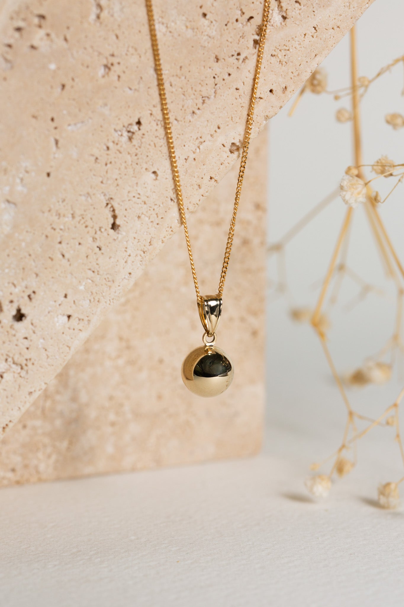 gold full ball pendant on a chain