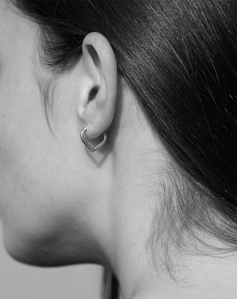 Love hoop earrings worn by a model