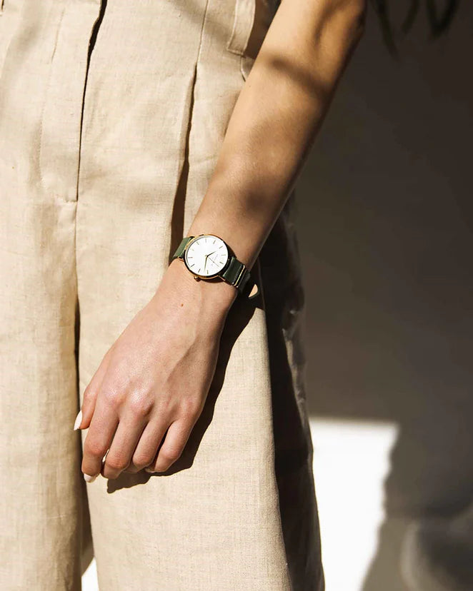 Ladies gold watch with green leather strap