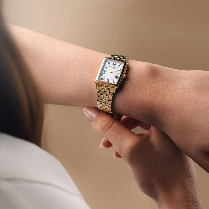 Raymond Weil Toccata rectangular gold watch worn on a woman's wrist