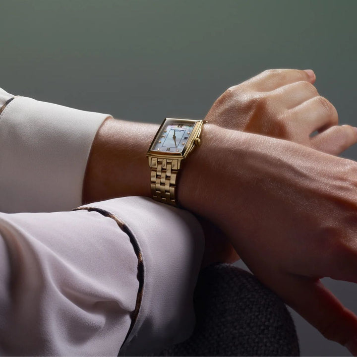 Raymond Weil Toccata gold mother-of-pearl diamond watch worn on a woman's wrist