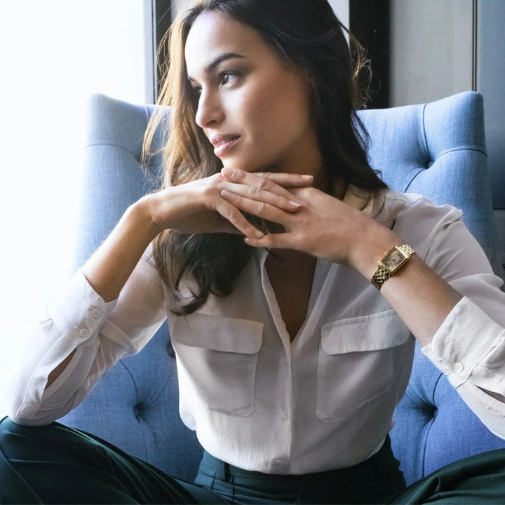 Raymond Weil Toccata gold champagne dial watch worn on a woman's wrist