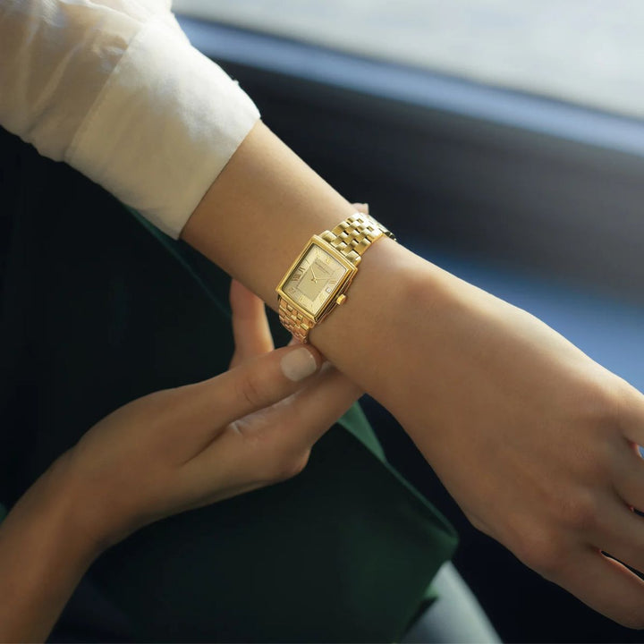 Raymond Weil Toccata gold champagne dial watch worn on a woman's wrist close up