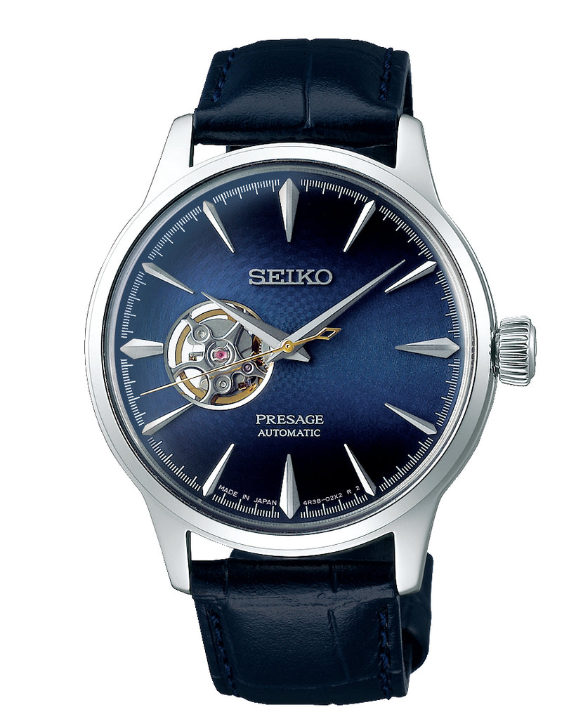 Seiko Presage watch with a blue dial and blue leather strap.  There is an open heart on the dial which shows the inside of the watch