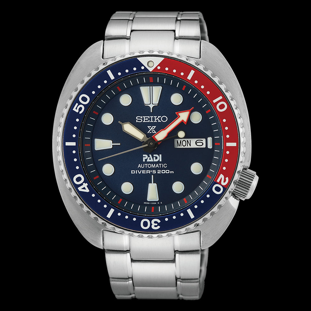 Seiko x PADI automatic mens divers watch.  The watch has a blue dial and a pepsi bezel