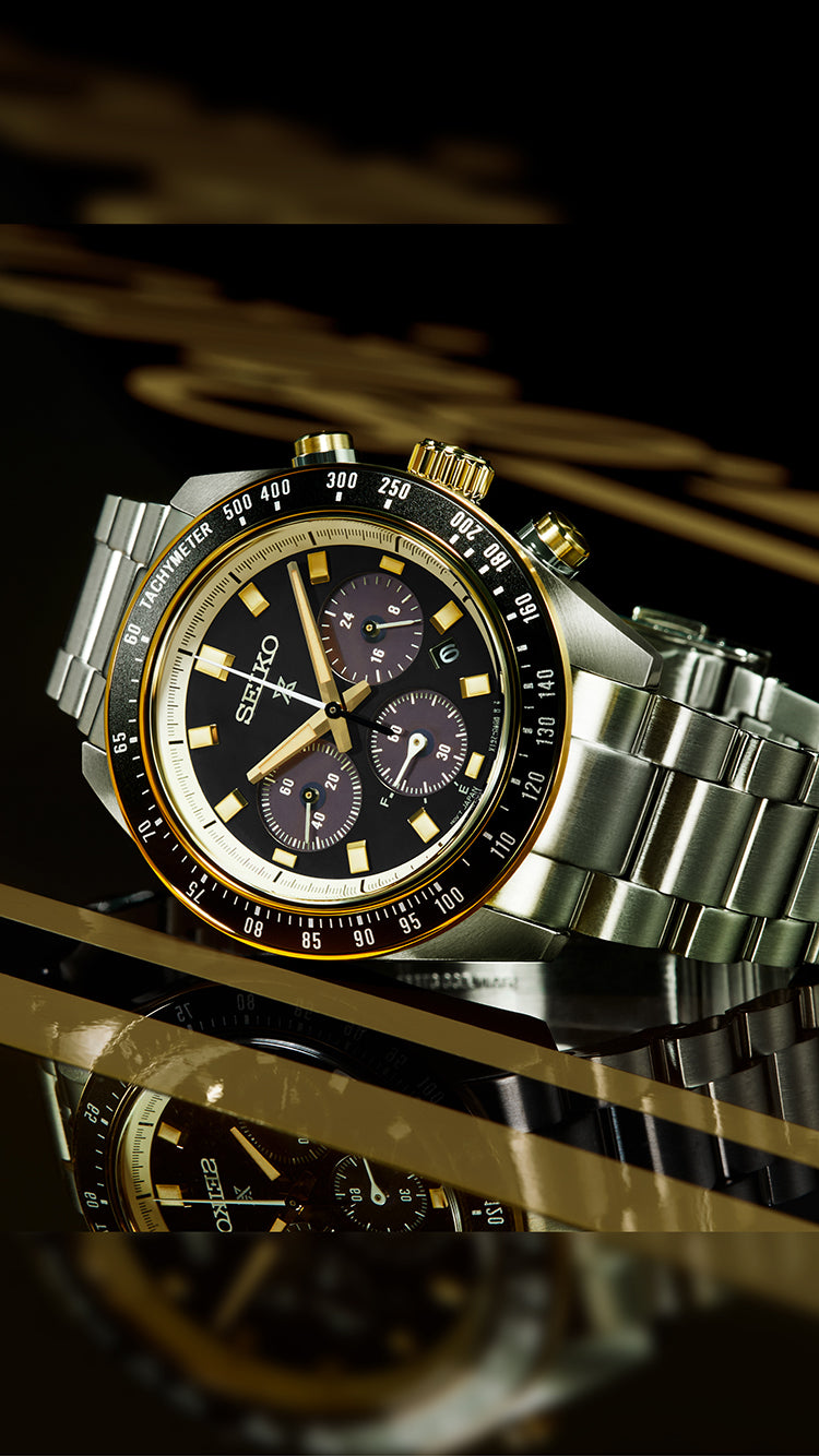 Mens Seiko Prospex watch with black and gold dial and black and gold bezel