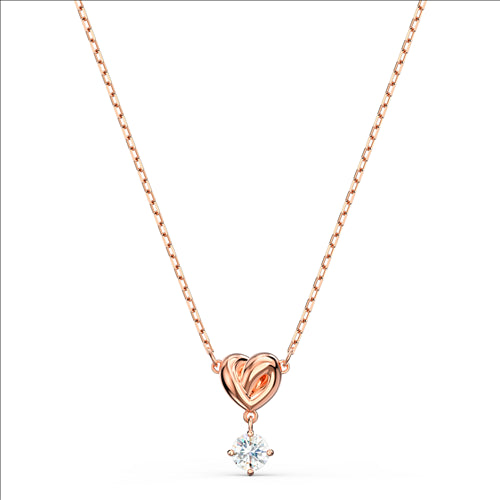 Rose gold heart necklace with a swarovski crystal dangling from it