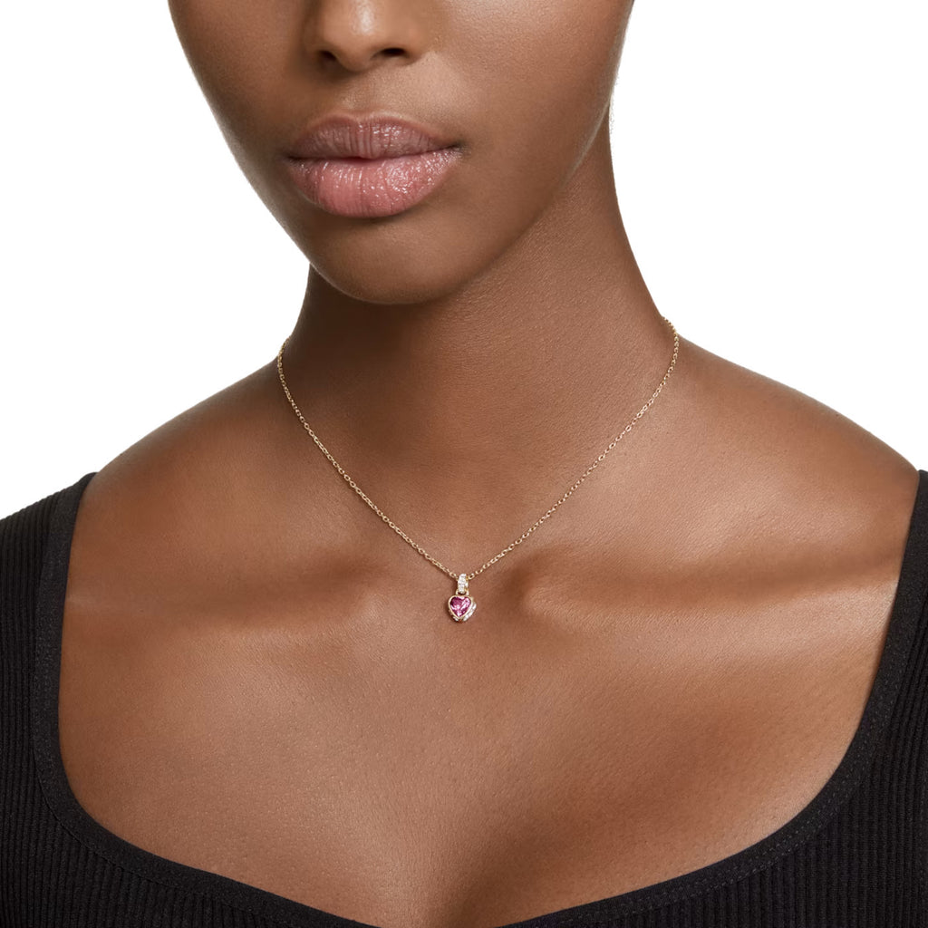 Gold necklace with a red heart