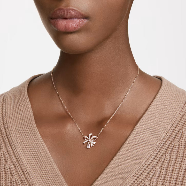 Rose gold bow necklace worn by a model