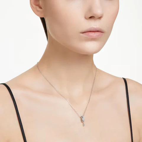 A model is wearing the silver Swarovski Dextera pendant