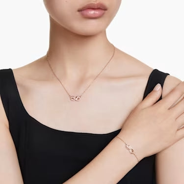Model wearing a matching infinity necklace and bracelet