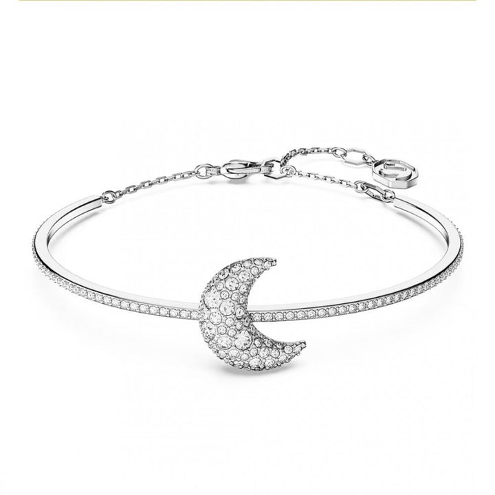 Silver bangle with a crescent moon on it.  The crescent moon has Swarovski crystals pave set all over it.