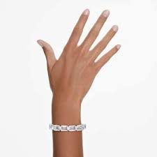 A model is wearing the Swarovski Hyperbola Bangle