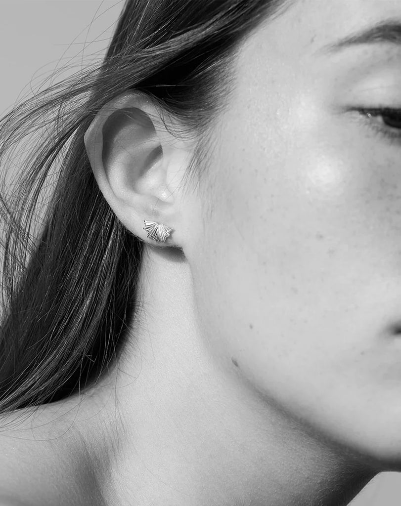 Model wearing silver Vita stud earrings by Meadowlark